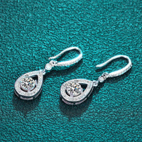 Timeless drop design. Sparkling pear-cut moissanite in a graceful halo setting for effortless elegance. - Diamond-Lab