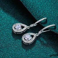 Timeless drop design. Sparkling pear-cut moissanite in a graceful halo setting for effortless elegance. - Diamond-Lab