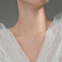 S925 sterling silver plated heart pendant necklace with sparkling moissanite stones for women.