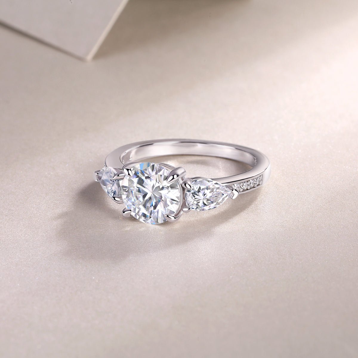 Three-stone engagement ring detail shot - side stones and band setting, S925 sterling silver