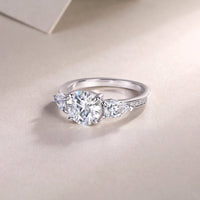 Three-stone engagement ring detail shot - side stones and band setting, S925 sterling silver