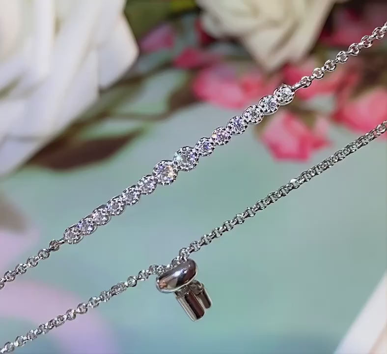 Adjustable moissanite bracelet in 925 sterling silver with white gold plating, featuring round prong-set stones and a sliding clasp.