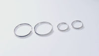 Close-up video of moissanite hoop earrings set in 925 sterling silver with white gold plating, showing sparkling round stones