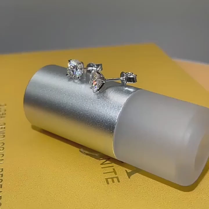 Round-cut moissanite stud earrings crafted from 925 sterling silver, shown in close-up video